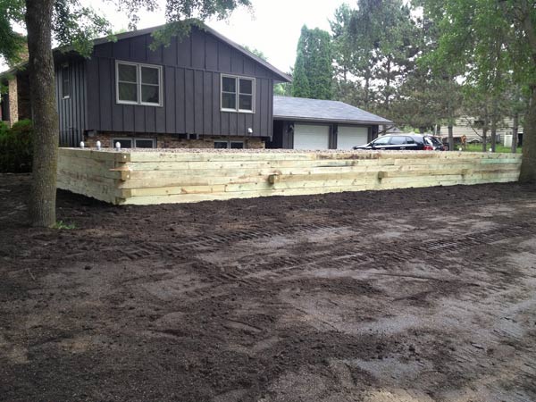 House with a wooden fence — Cedar, MN — Casper's Excavating
