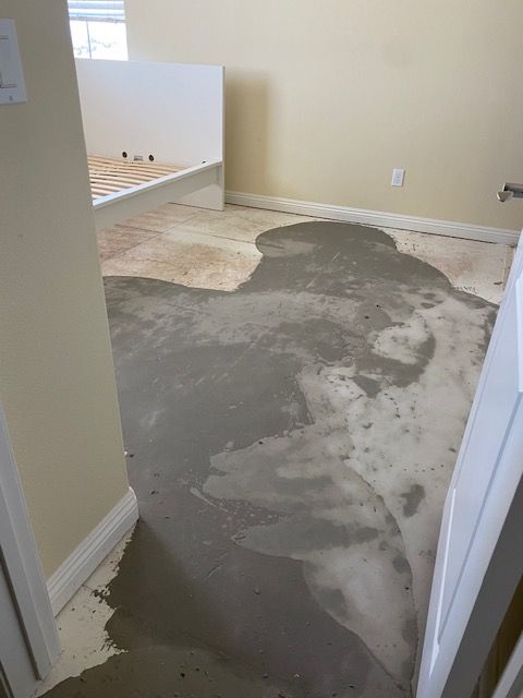 A room with a lot of concrete on the floor.