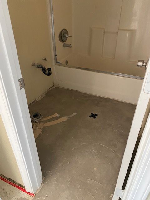 A bathroom with a bathtub and a shower stall.