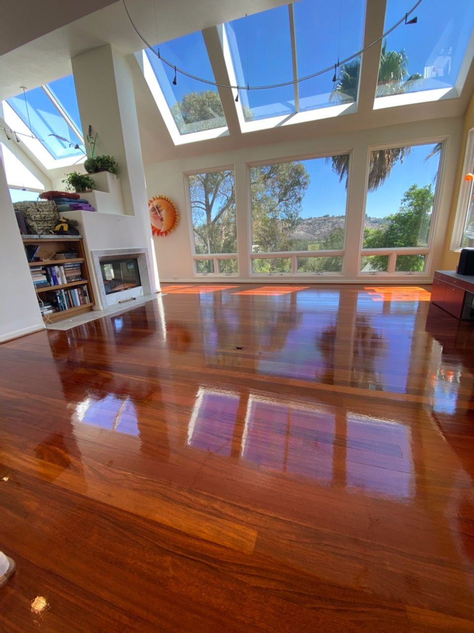 A living room with hardwood floors and lots of windows