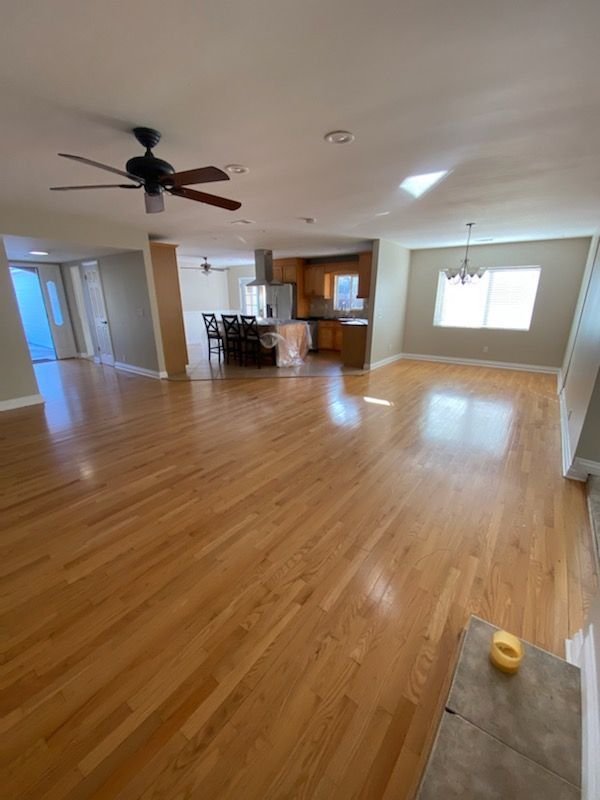 floor installation carlsbad living room with hardwood floors and a window.