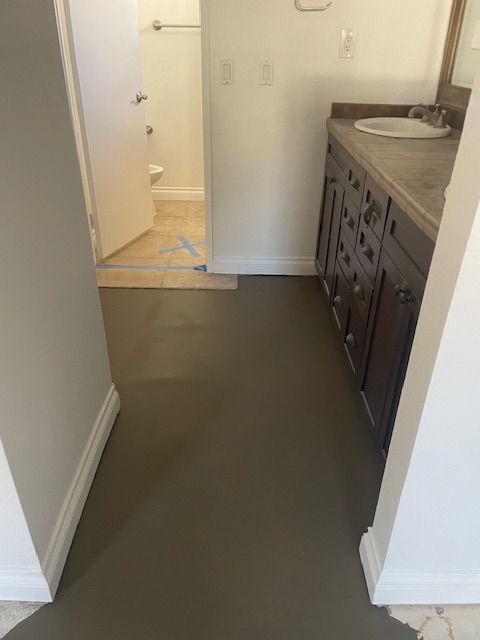 A bathroom with a sink and a toilet in it.