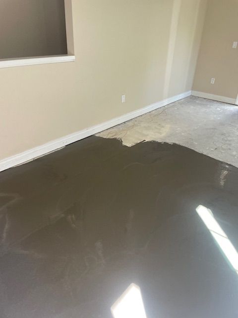A living room with a concrete floor and a window.