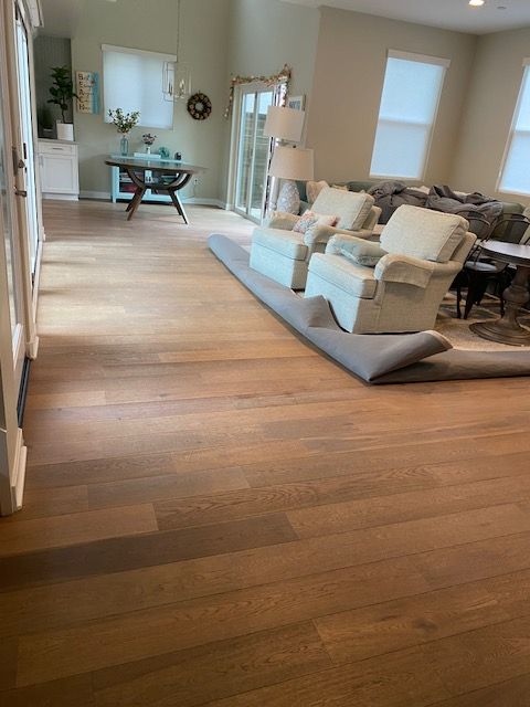A living room with hardwood floors and a rug on the floor.