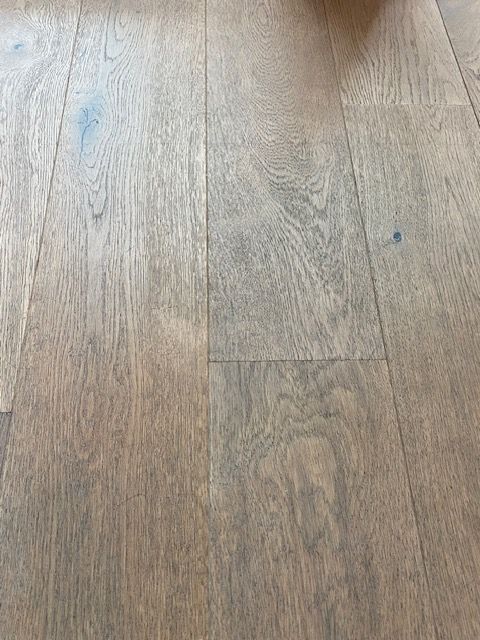 A close up of a wooden floor in a living room.