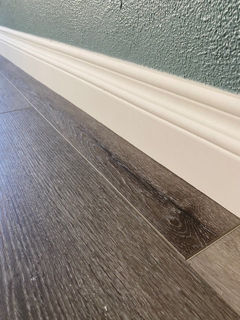Flooring repairs with new baseboards in Hillcrest.