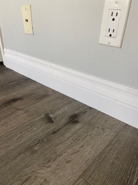 Vinyl flooring installation and baseboard repairs in Oceanside.