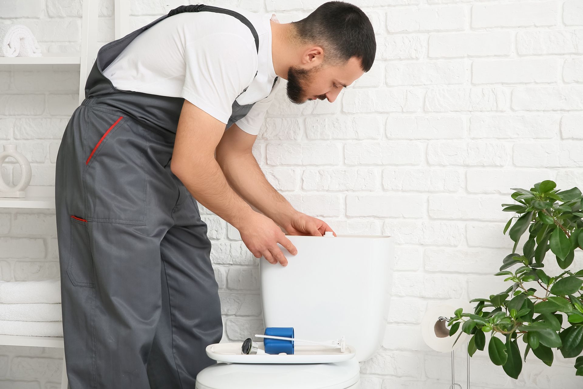 Plumber installing a toilet. 