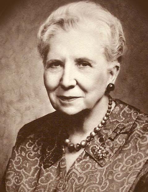 A black and white photo of an older woman wearing a necklace