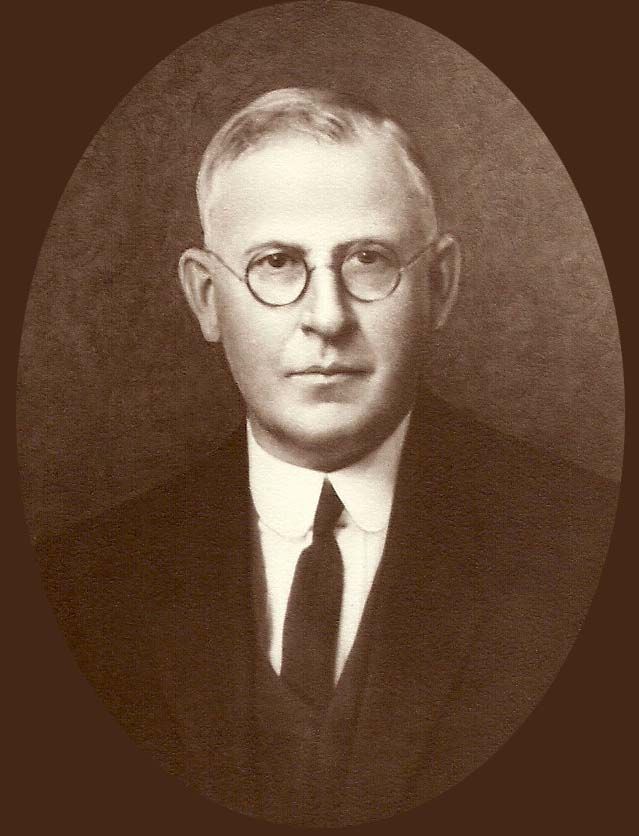 A man in a suit and tie is wearing glasses