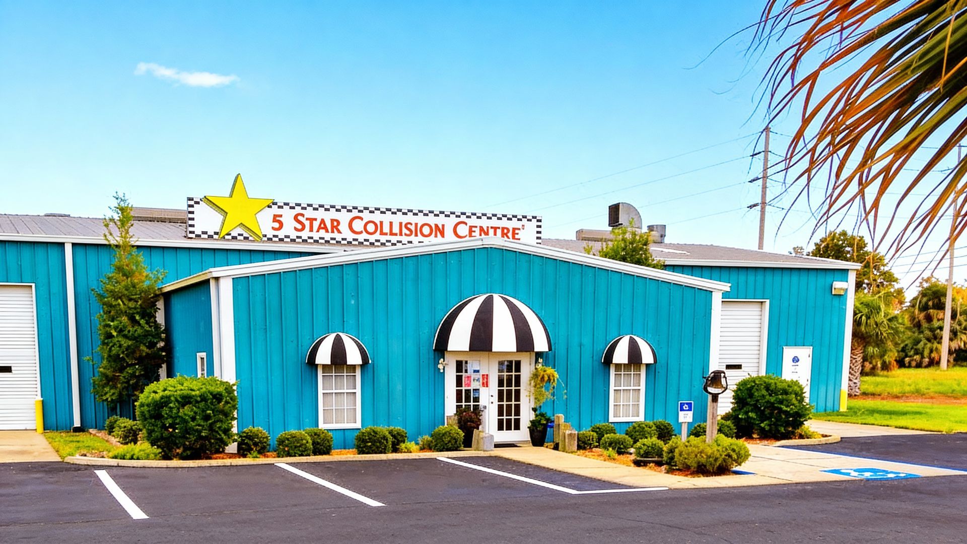 Blue auto repair shop with black and white awnings; 