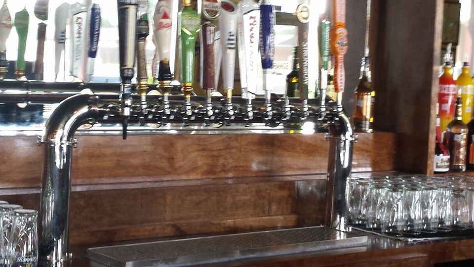 A bar with a lot of beer taps on it