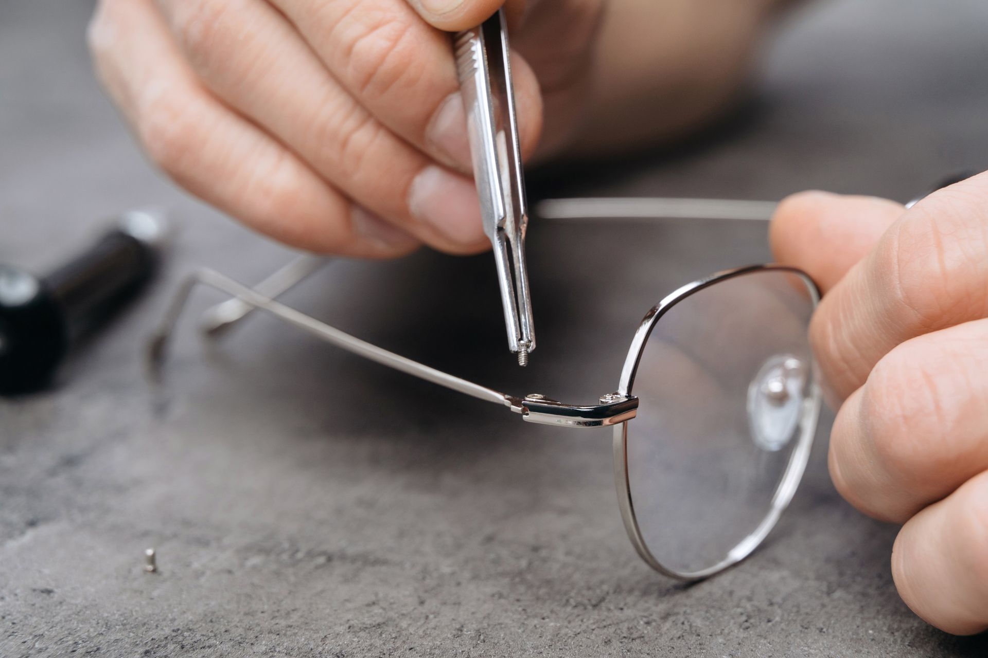 man fixing glasses