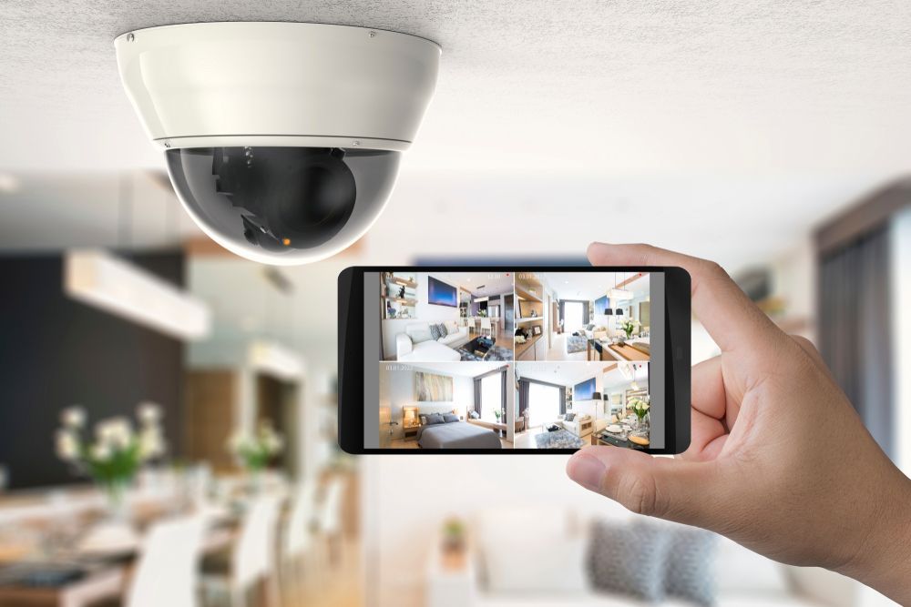 Hand Holding Smartphone Showing Home Security Camera Feed — Terrace Locksmiths in Raymond Terrace, NSW