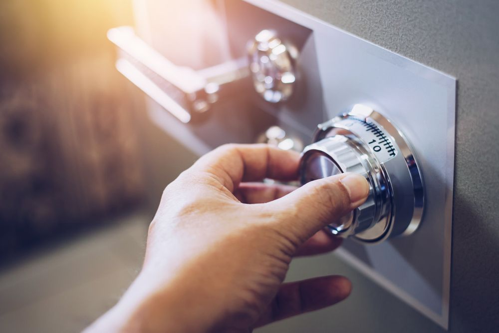 Hand Turning a Chrome Safe Dial on A Metal Door — Terrace Locksmiths in Raymond Terrace, NSW