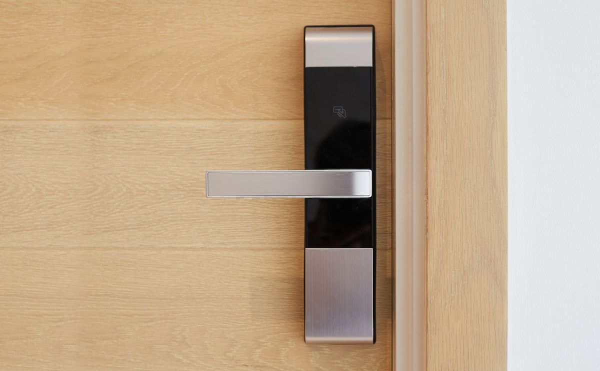 Modern Silver Door Handle on a Light Wood Door — Terrace Locksmiths in Raymond Terrace, NSW