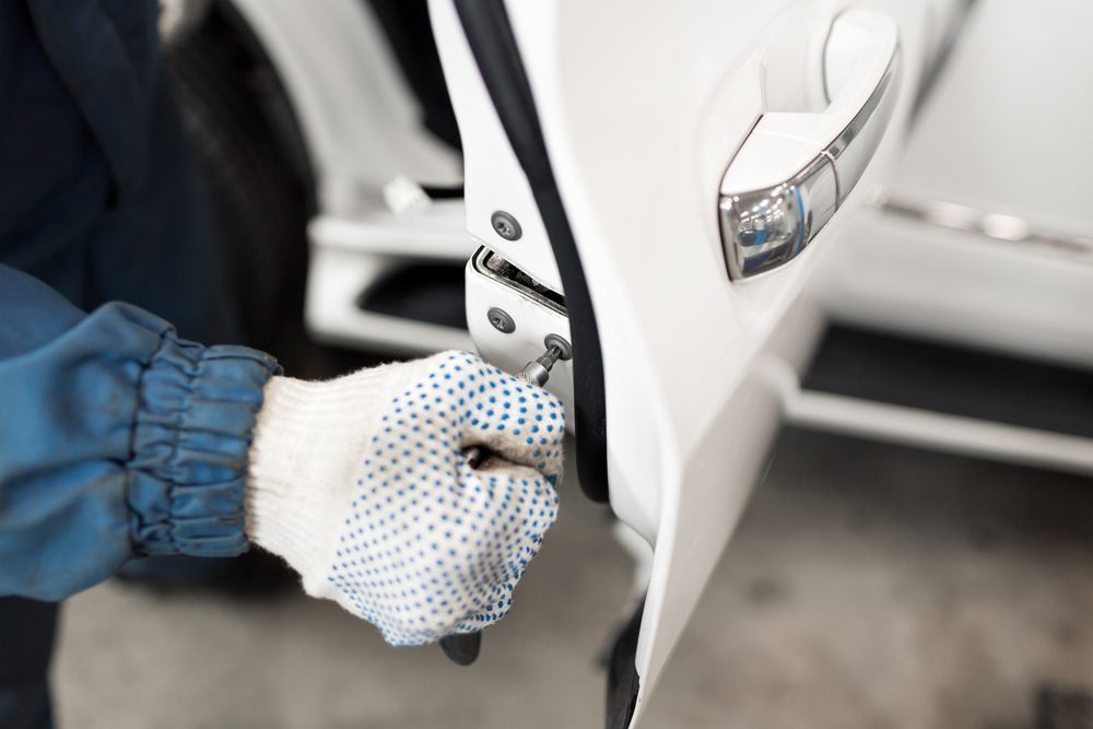 Gloved Hand Opening a White Car Door Near the Curb — Terrace Locksmiths in Port Stephens, NSW