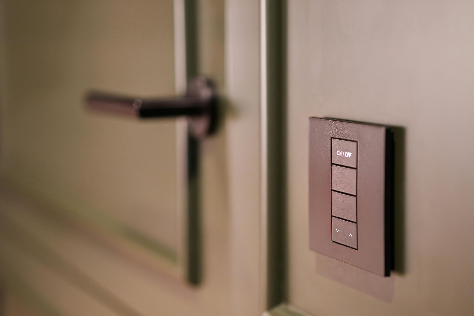 Wall-Mounted Light Switch Panel Beside a Door Handle — Terrace Locksmiths in Raymond Terrace, NSW