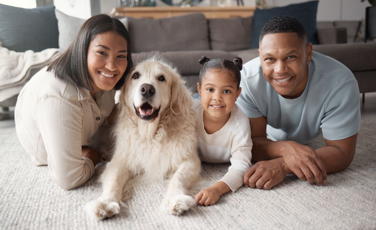 family on carpet with dog 