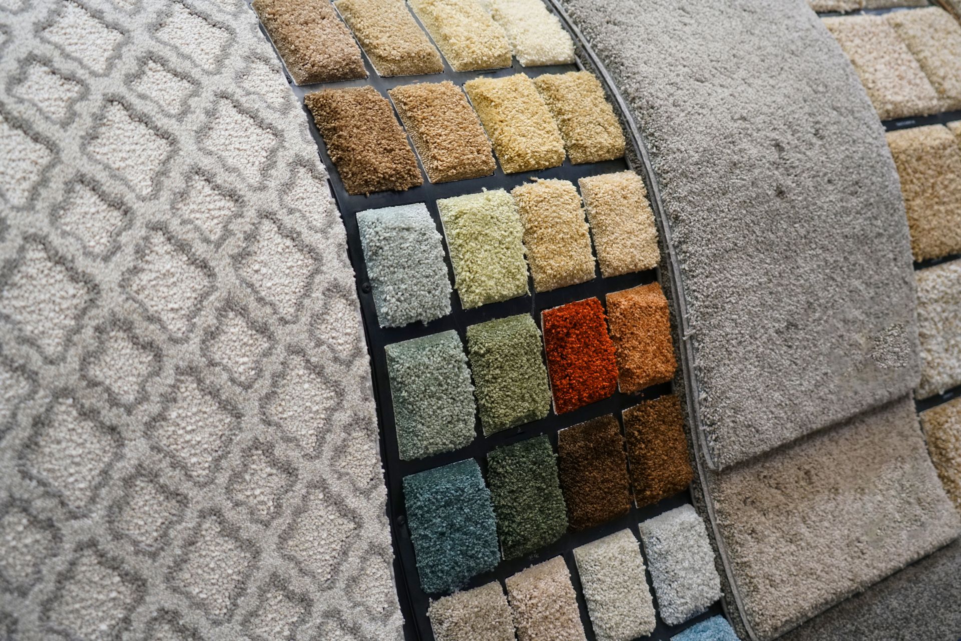 Carpet samples with various colors and textures displayed for selection.