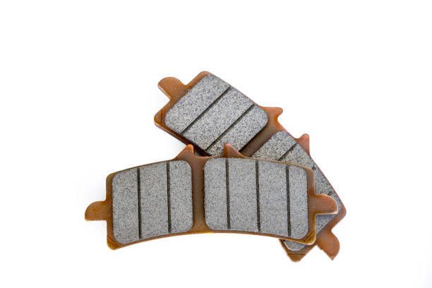 A Couple of Brake Pads Against a White Background