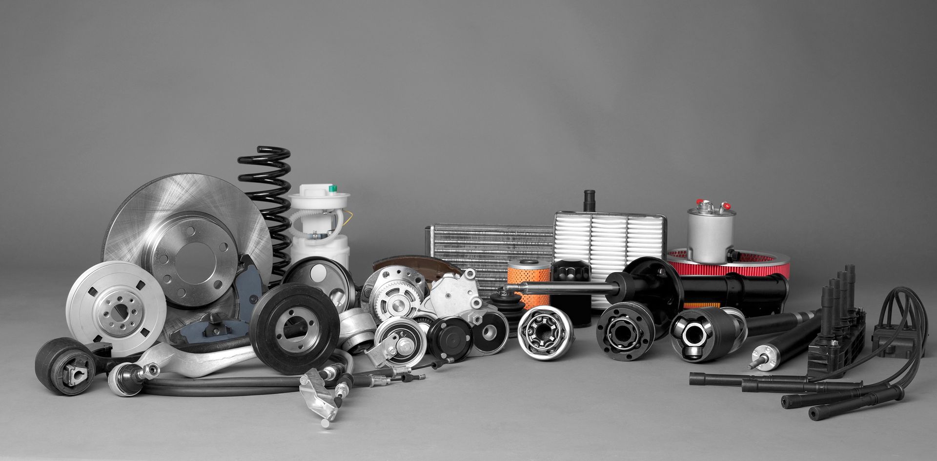New car parts on a gray background closeup - Auto Parts in Granada, Ca
