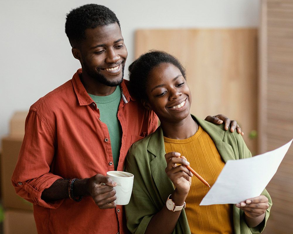 A man and a woman are looking at a piece of paper.