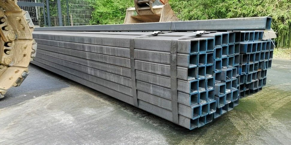 A Stack of Metal Pipes is Sitting on the Ground — Top End Steel Supplies Darwin In Pinelands, NT