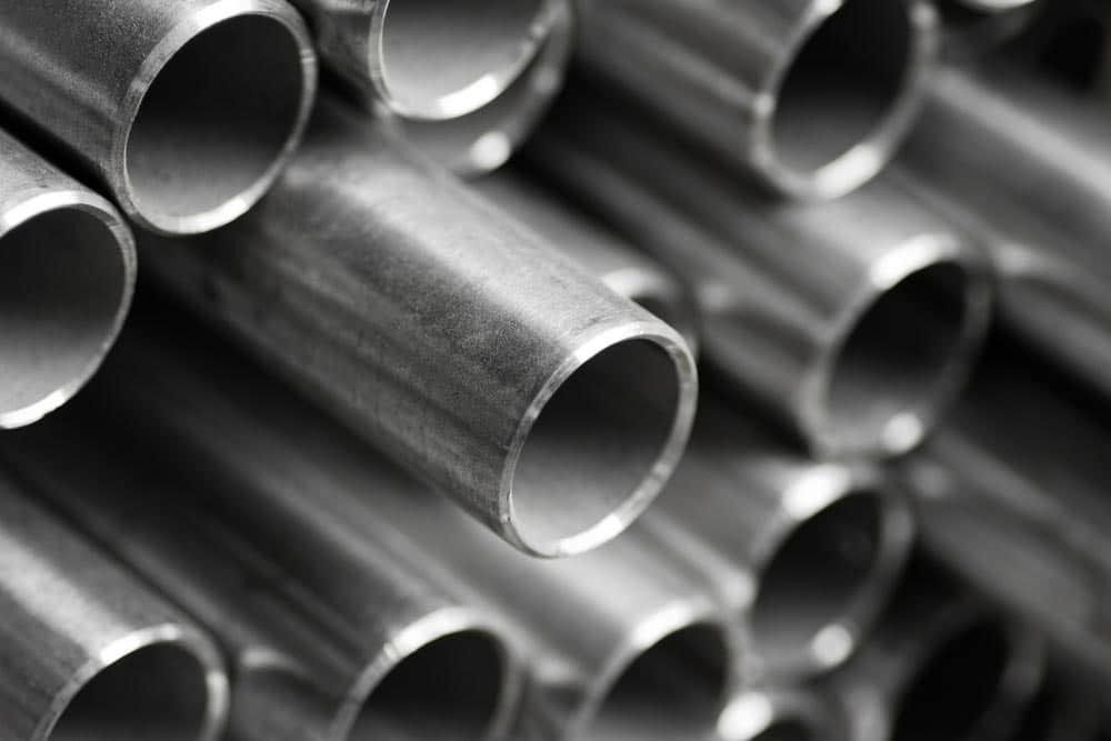 A Close Up of a Pile of Metal Pipes Stacked on Top of Each Other — Top End Steel Supplies Darwin In Pinelands, NT