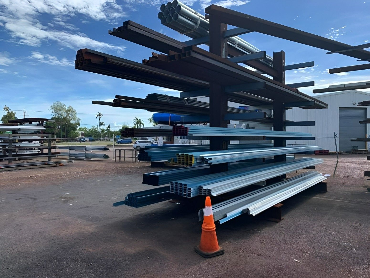 A Bunch of Metal Pieces Are Stacked on Top of Each Other in a Parking Lot — Top End Steel Supplies Darwin In Pinelands, NT