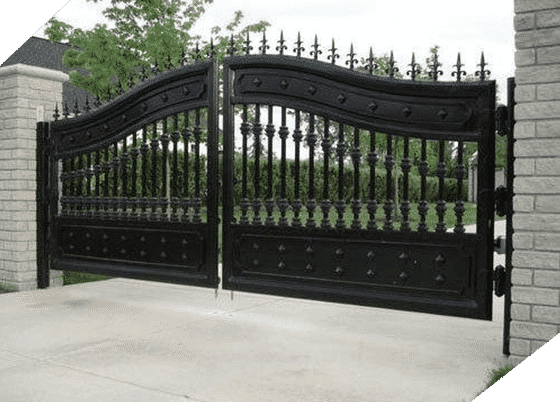 A Black Gate With a Brick Wall Behind It — Top End Steel Supplies Darwin In Pinelands, NT