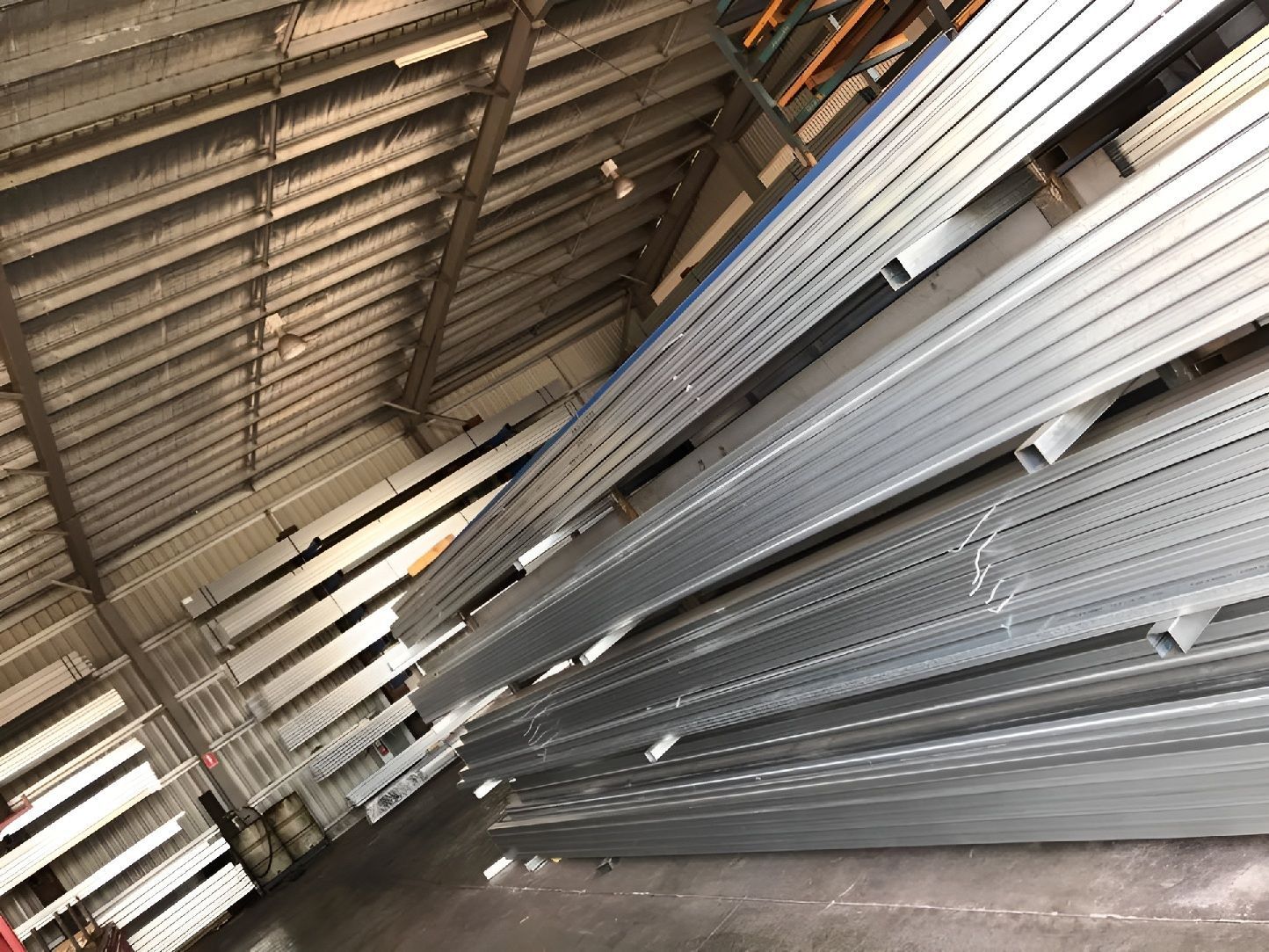 Stacked Steel Beams In Warehouse For Custom Fabrication
