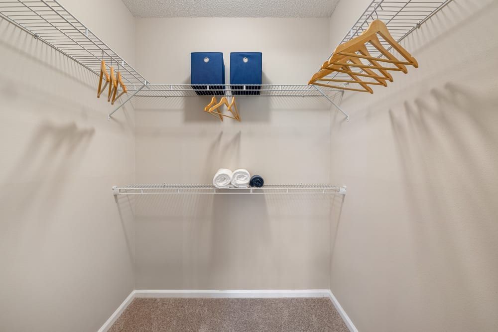 a walk in closet with a lot of clothes hanging on the racks at The Preserve at Ballantyne Commons in Charlotte, NC.