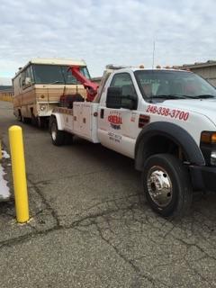 Tow Car Towing a Bus — Auburn Hills, MI — General Towing Auburn Hills