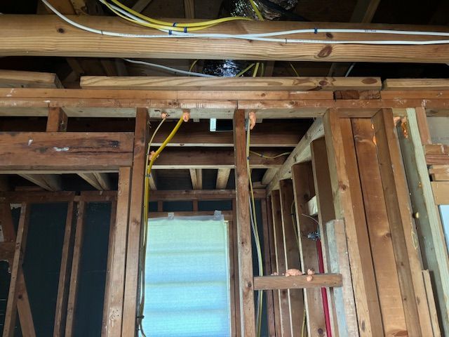 A man is working on the ceiling of a house under construction.