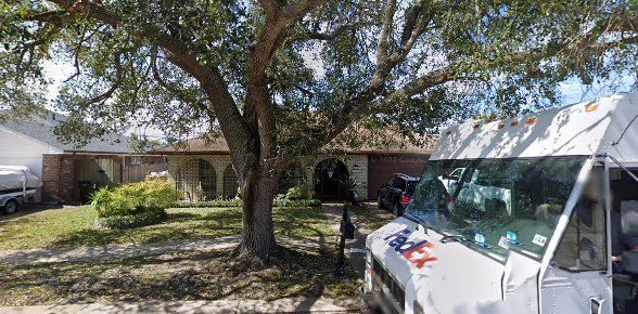 A fedex truck is parked in front of a house.