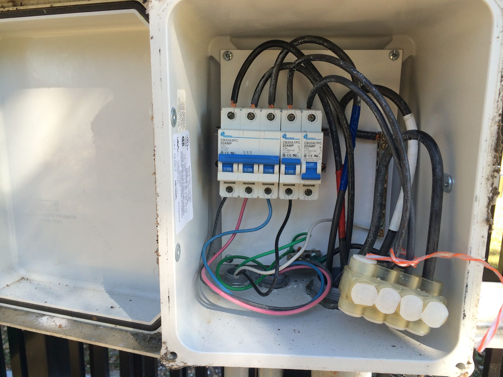 An electrical box with a breaker and wires inside of it