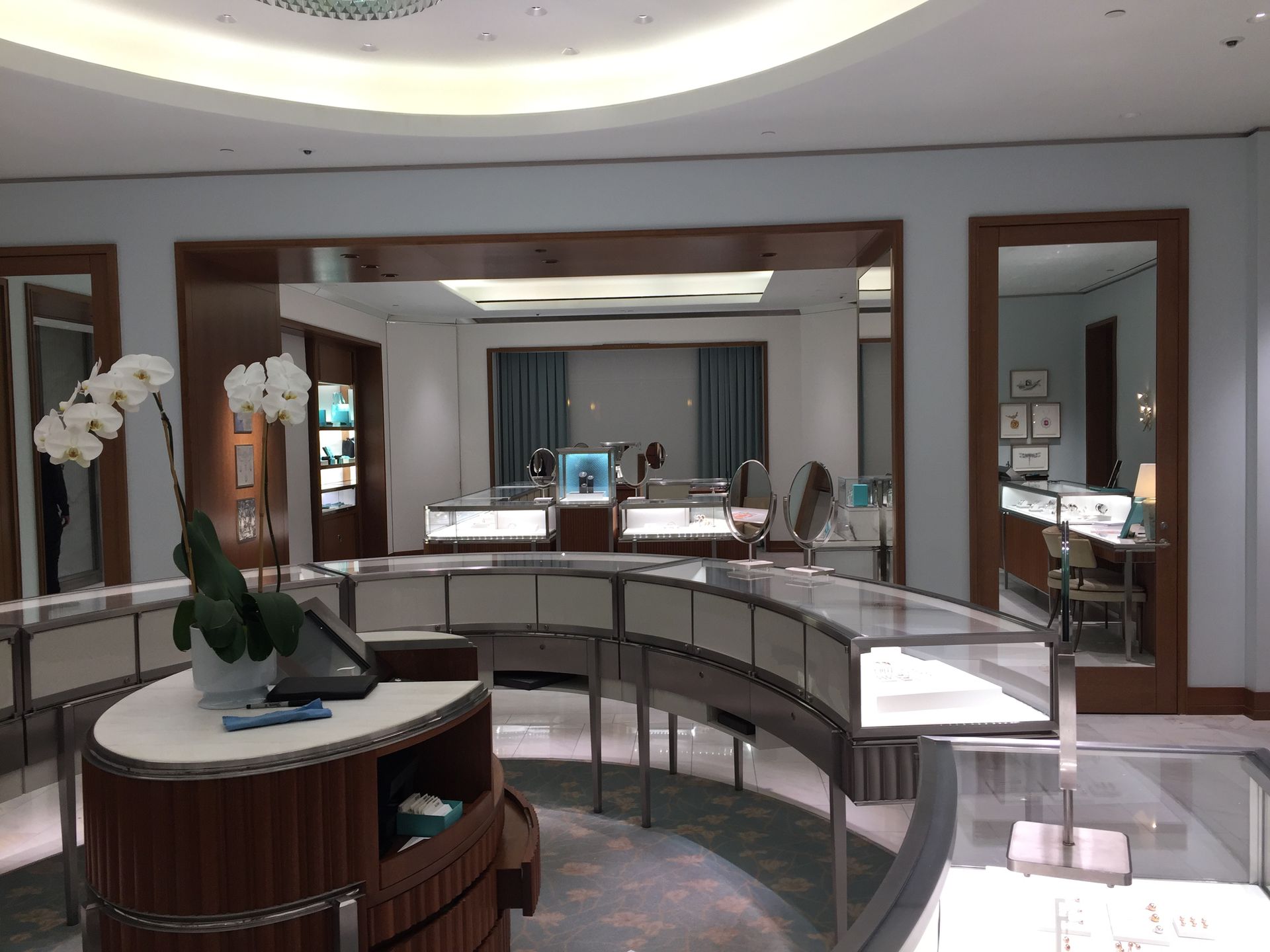 A jewelry store with a round table in the middle of the room.