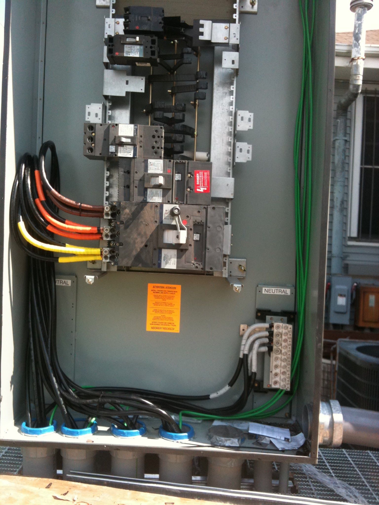 The inside of a electrical box with a warning sign on it
