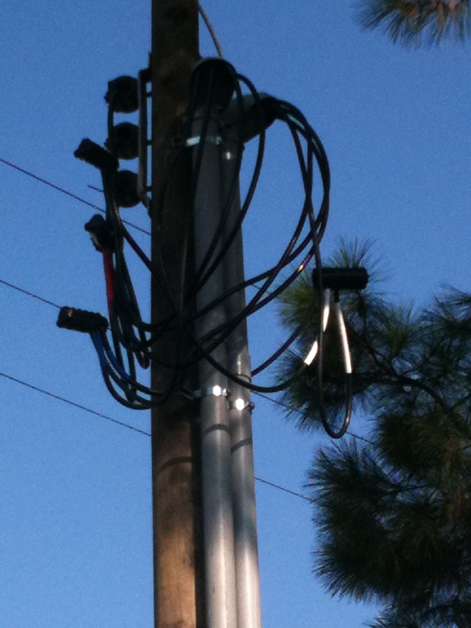 A pole with a bunch of wires attached to it