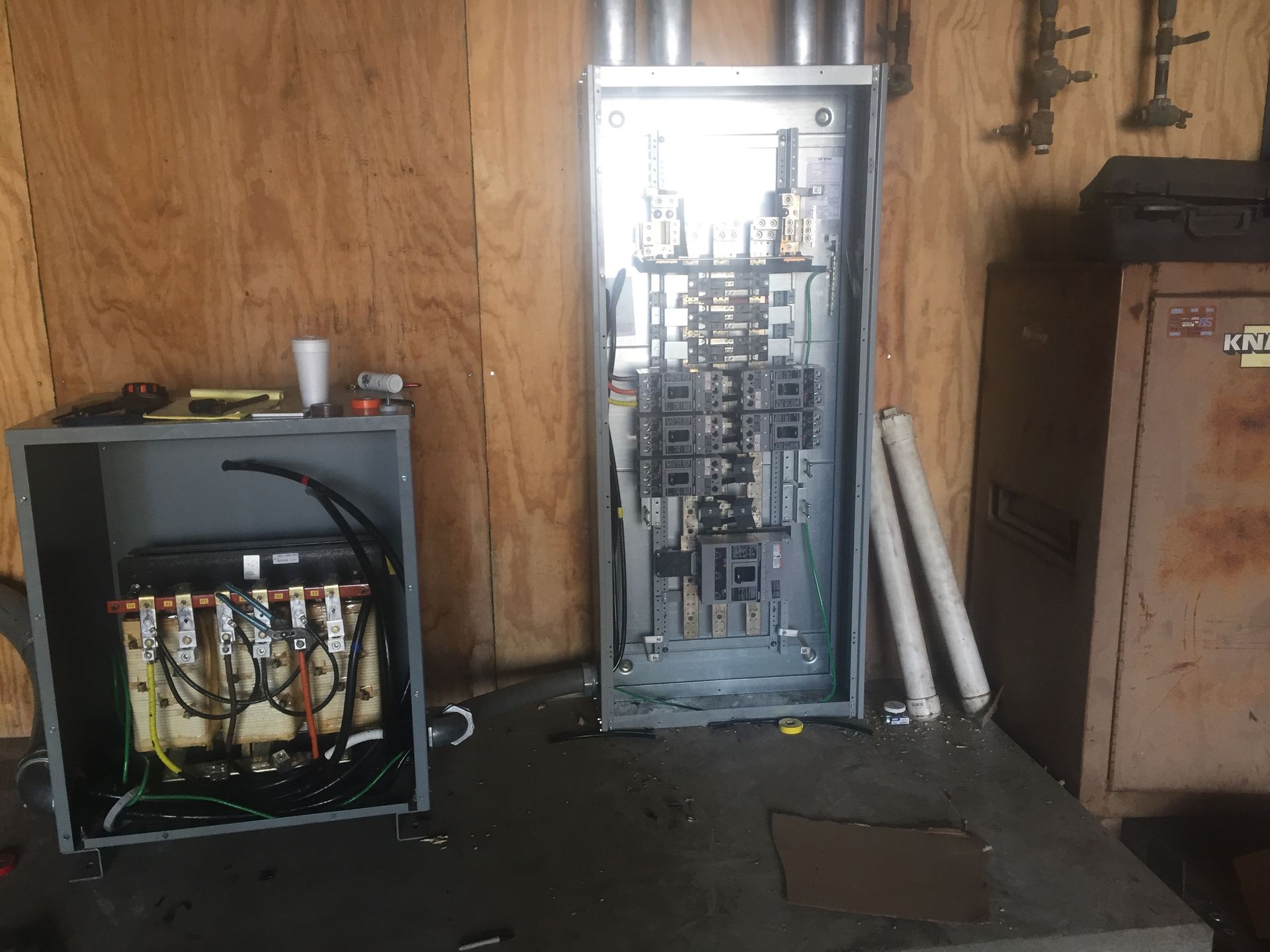 An electrical box is sitting in a room next to a safe