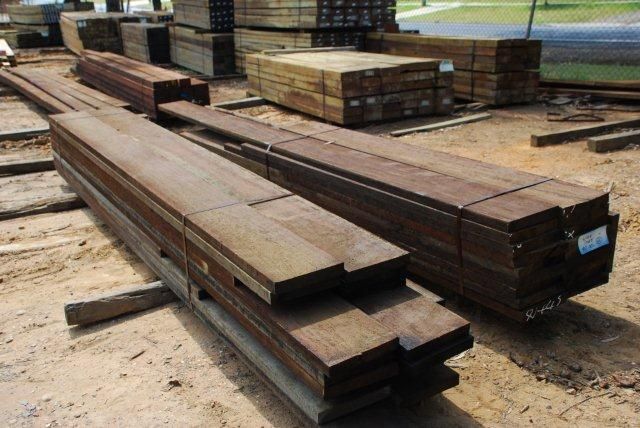 A pile of wood is stacked on top of each other on the ground.