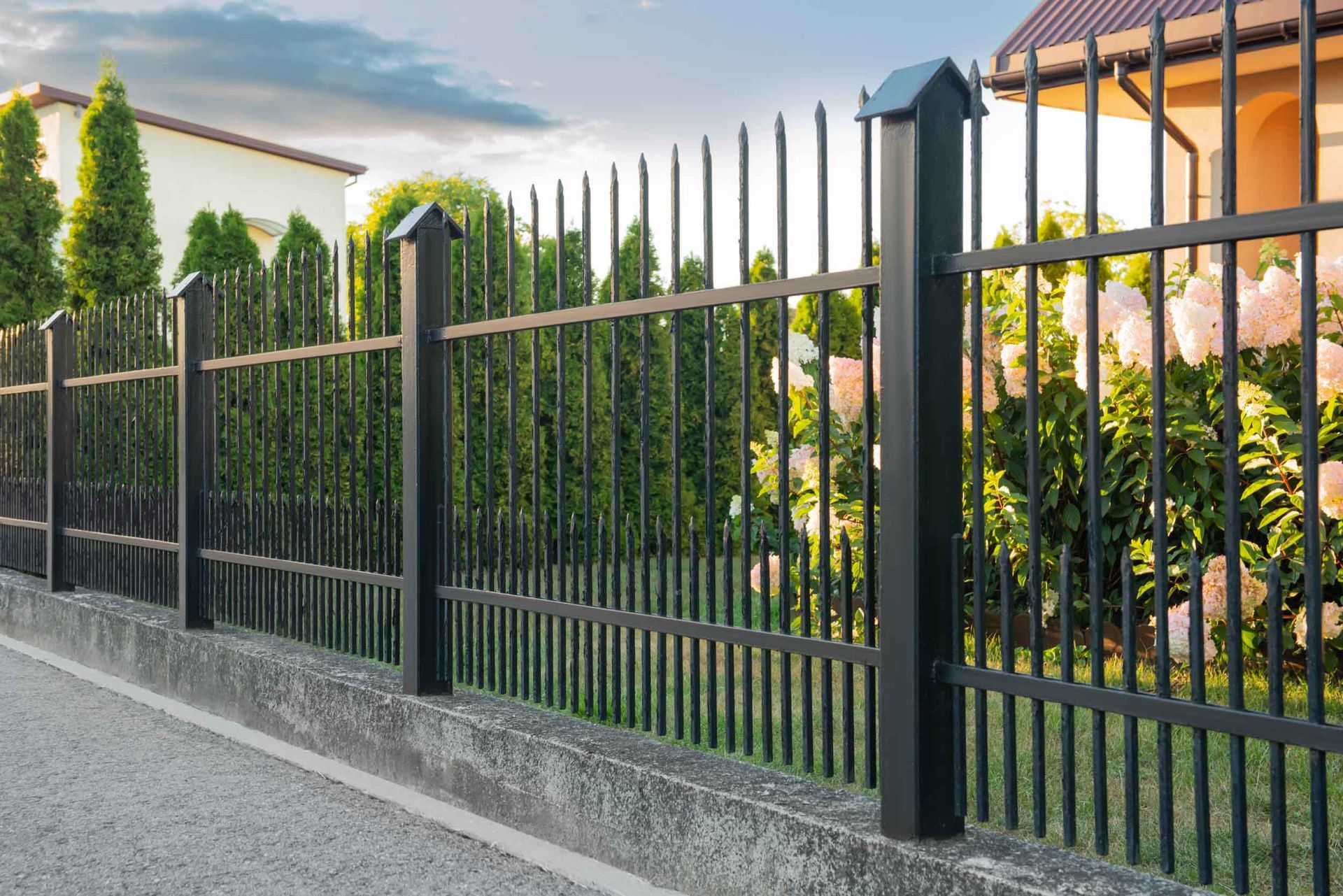 Beautiful black iron fence near a pathway outdoors. Beautiful black iron fence near a pathway outdoors.