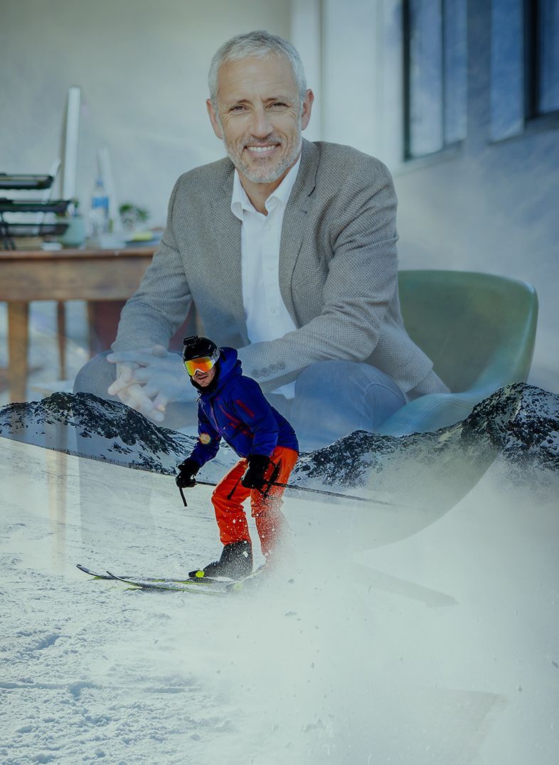 Skier on snowy mountain, with a smiling businessman in a suit superimposed in the background.