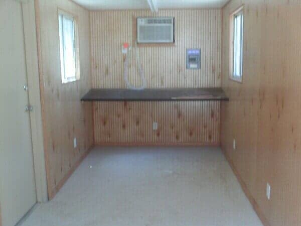 Inside of Simple Trailer Office with Wooden Wallpaper - Storage Unit Homes in Albuquerque, NM