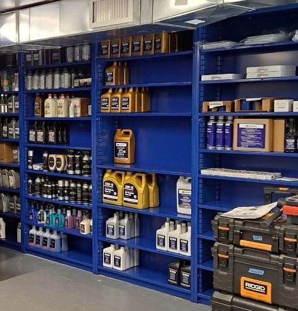 A row of blue shelves filled with lots of bottles and boxes