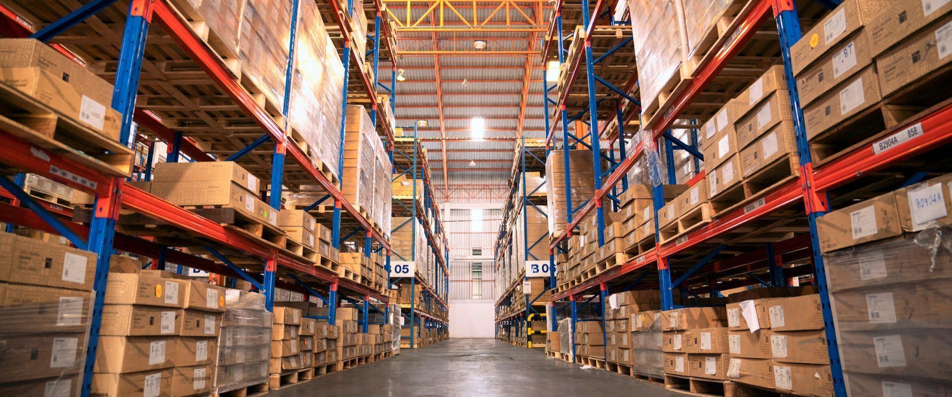 A large warehouse filled with lots of boxes and shelves.