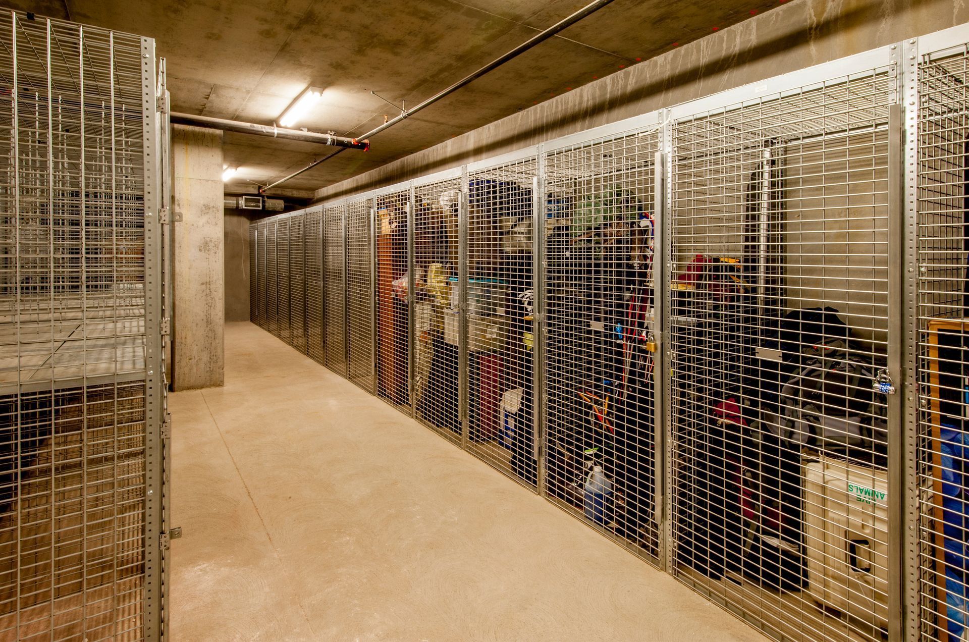 A row of lockers filled with lots of items in a warehouse.