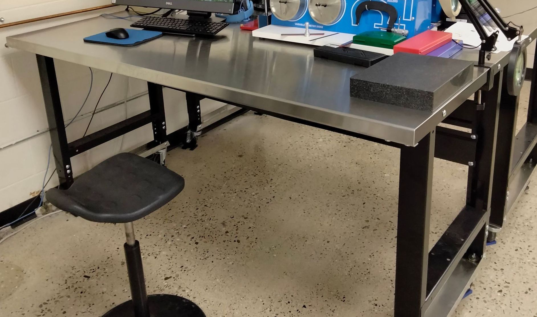 A stainless steel desk with a computer on it