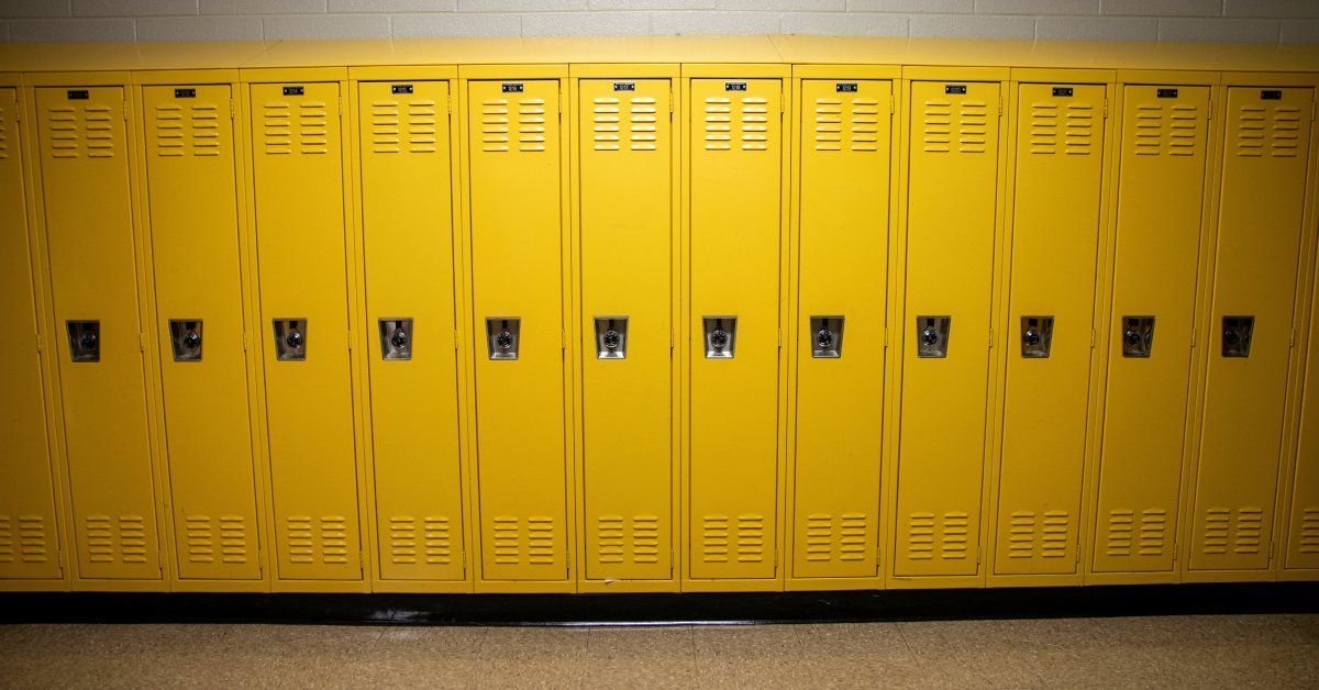 Vibrant yellow metal lockers lining the high school hallway provide color and a secure storage solution for students.